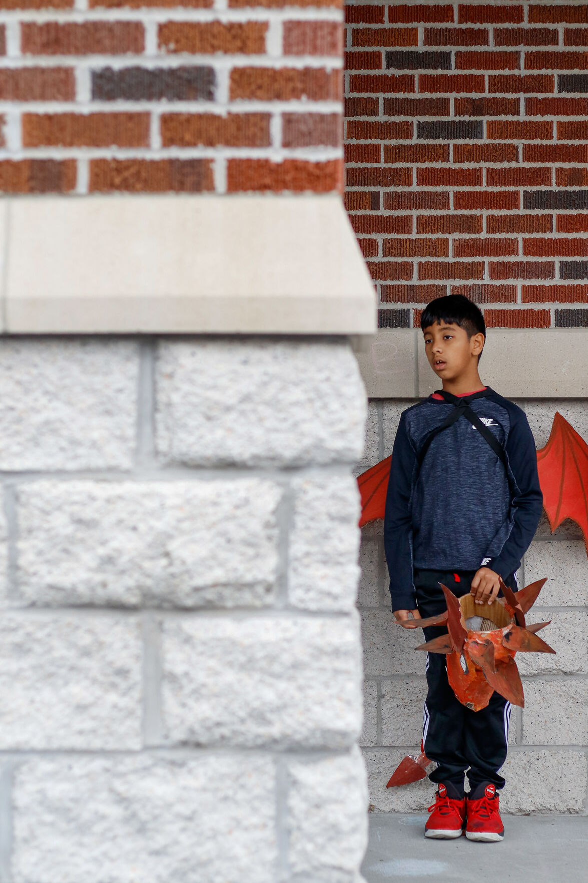 Ishaan Mishra, a third grader, stands outside of Locust Street Expressive Arts Elementary School